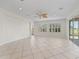 Bright, spacious living room featuring tile flooring, natural light, and a decorative ceiling fan at 12886 Se 97Th Terrace Rd, Summerfield, FL 34491