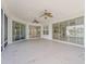 Covered patio featuring ceiling fans and sliding glass doors offering an indoor/outdoor living space at 12886 Se 97Th Terrace Rd, Summerfield, FL 34491