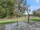 Stone patio in backyard, surrounded by grass and trees at 1303 E Schwartz Blvd, The Villages, FL 32159