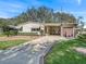 House exterior featuring a carport and well-maintained lawn at 1303 E Schwartz Blvd, The Villages, FL 32159