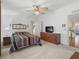 Spacious main bedroom with a tv and dresser at 1303 E Schwartz Blvd, The Villages, FL 32159