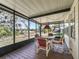 Relaxing screened porch with seating area and view of nature at 1303 E Schwartz Blvd, The Villages, FL 32159