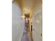 Long hallway with light colored walls and carpeted floors at 13415 Blue Heron Beach Dr # 1501, Orlando, FL 32821