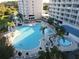 Condo building with inviting pool and lush landscaping at 13415 Blue Heron Beach Dr # 1501, Orlando, FL 32821