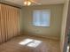 Neutral bedroom with tiled floors, light green walls and a window at 1511 Spanish Ave, Leesburg, FL 34748