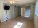 Another Bedroom with tiled floors, light green walls, ceiling fan, and a connected closet space at 1511 Spanish Ave, Leesburg, FL 34748