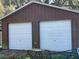 Detached garage with two white garage doors at 1511 Spanish Ave, Leesburg, FL 34748