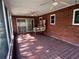 Enclosed brick patio with tile flooring, windows, and ceiling fans at 1511 Spanish Ave, Leesburg, FL 34748