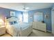 Charming bedroom featuring a white bed frame, floral bedding, and matching white dresser and nightstand furniture at 1541 Fenimore Ln, The Villages, FL 32162