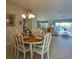 Bright dining area with an oval table set for dining, with views through the home's open floor plan at 1541 Fenimore Ln, The Villages, FL 32162