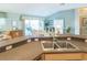 Bright kitchen featuring a stainless steel sink, natural light, and views into the dining and living area at 1541 Fenimore Ln, The Villages, FL 32162