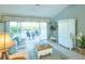 Bright living room featuring neutral tones, comfortable seating, and sliding glass doors to the patio at 1541 Fenimore Ln, The Villages, FL 32162