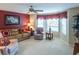 Cozy living room with ceiling fan, bay window, and comfortable seating area at 1541 Fenimore Ln, The Villages, FL 32162