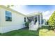 Inviting screened-in patio with steps leading to a manicured lawn and lush landscaping, perfect for outdoor relaxation at 1541 Fenimore Ln, The Villages, FL 32162