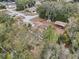 Aerial view of a house nestled among trees, showcasing a spacious backyard and surrounding neighborhood at 15831 Se 89Th Ter, Summerfield, FL 34491