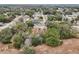 Wide shot showing the house's location in a residential area with tree-lined streets and neighboring homes at 15831 Se 89Th Ter, Summerfield, FL 34491