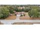 Aerial view of a house with a large yard and surrounding trees at 15831 Se 89Th Ter, Summerfield, FL 34491