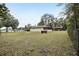 Large backyard with grassy area and partial wooden fence at 15831 Se 89Th Ter, Summerfield, FL 34491