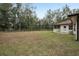 Large backyard with grassy area and partial wooden fence at 15831 Se 89Th Ter, Summerfield, FL 34491