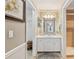 Bathroom with white vanity, mirror, and neutral tile flooring at 15831 Se 89Th Ter, Summerfield, FL 34491