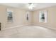 Spacious bedroom with neutral walls, carpeting, and multiple windows at 15831 Se 89Th Ter, Summerfield, FL 34491