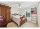 Bedroom with wooden bed frame and antique wardrobe at 15831 Se 89Th Ter, Summerfield, FL 34491