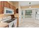 Bright kitchen features wood cabinets, white appliances, and a corner window at 15831 Se 89Th Ter, Summerfield, FL 34491