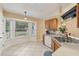 Kitchen with wood cabinets, stainless steel sink, and view to backyard at 15831 Se 89Th Ter, Summerfield, FL 34491