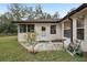 Small patio with concrete slab, small plants, and hose at 15831 Se 89Th Ter, Summerfield, FL 34491