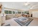 Sunroom with built-in shelving, a large rug, and plenty of natural light at 15831 Se 89Th Ter, Summerfield, FL 34491