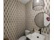 Stylish powder room with patterned wallpaper and modern vanity at 16254 Ravenna Ct, Bella Collina, FL 34756