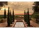 Landscaped courtyard with reflecting pool and sunset view at 16254 Ravenna Ct, Bella Collina, FL 34756