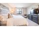 Bright bedroom featuring a large window with water views, complemented by stylish decor at 16300 County Road 455 # 414, Bella Collina, FL 34756