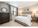 Cozy bedroom featuring soft lighting, a plush bed, and elegant window treatments at 16300 County Road 455 # 414, Bella Collina, FL 34756