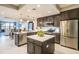 Spacious kitchen with stainless steel appliances, a center island, and eat-in bar seating at 16300 County Road 455 # 414, Bella Collina, FL 34756