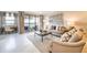 Inviting living room featuring neutral tones, large windows with water views, and comfortable seating at 16300 County Road 455 # 414, Bella Collina, FL 34756