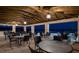 Spacious outdoor seating area with tables and chairs under a wooden pergola overlooking a peaceful waterfront view at 16300 County Road 455 # 414, Bella Collina, FL 34756