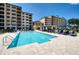 Community pool area with ample lounge seating, shaded umbrellas, and manicured landscaping at 16300 County Road 455 # 414, Bella Collina, FL 34756