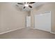 Bright bedroom featuring carpet, double-door closet, and ceiling fan at 16904 Se 110Th Court Rd, Summerfield, FL 34491