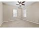 Well-lit bedroom with carpet flooring, two windows with shutters, and ceiling fan at 16904 Se 110Th Court Rd, Summerfield, FL 34491