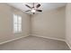 Spacious bedroom with carpet, window with shutters, and ceiling fan at 16904 Se 110Th Court Rd, Summerfield, FL 34491