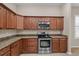 Kitchen features granite countertops and stainless steel appliances at 16904 Se 110Th Court Rd, Summerfield, FL 34491