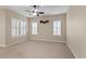 Living room with ceiling fan and large windows at 16904 Se 110Th Court Rd, Summerfield, FL 34491