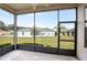 Relaxing screened porch overlooking backyard with view of neighboring home at 16904 Se 110Th Court Rd, Summerfield, FL 34491