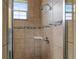 Shower with tile surround and built-in shelf at 16904 Se 110Th Court Rd, Summerfield, FL 34491