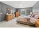 Bedroom with gray walls, ceiling fan, and wood furniture at 16958 Se 94Th Sunnybrook Cir, The Villages, FL 32162