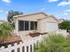 Tan exterior house with a white picket fence and landscaping at 16958 Se 94Th Sunnybrook Cir, The Villages, FL 32162