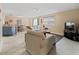 Bright living room with tile floors, sofa, and flat-screen TV at 16958 Se 94Th Sunnybrook Cir, The Villages, FL 32162