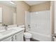 Bathroom with white tub and shower, and white vanity at 17461 Se 93Rd Retford Ter, The Villages, FL 32162