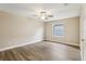 Spacious bedroom with ceiling fan and wood-look flooring at 17461 Se 93Rd Retford Ter, The Villages, FL 32162